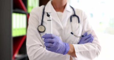 Otolaryngologist klinikte otoskopu elinde tutuyor. Kulak ağrısı ve işitme testi olan hastalara yardım etmek