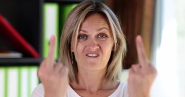 Angry aggressive woman showing middle finger. Girl makes fuck you bad expression provocation and rude attitude