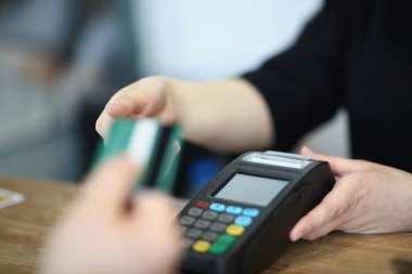 Satıcı kredi kartı almak için alıcı teklif ediyor. Mallar için ödeme terminali kavramı ile ödeme