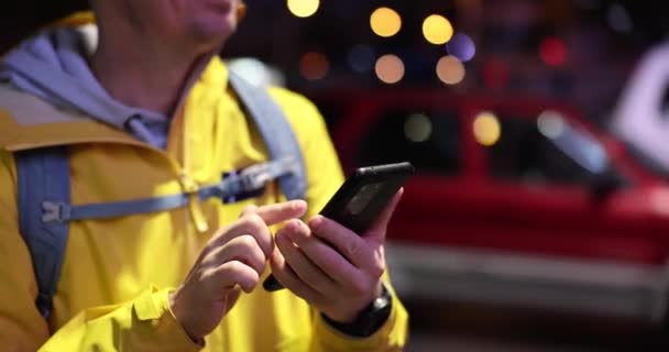 Ένας Ευτυχισμένος Άνθρωπος Βράδυ Στο Δρόμο Κοιτάζει Ένα Smartphone Ένα — Αρχείο Βίντεο