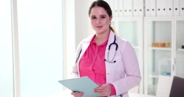 Gülümseyen bir kadın. Bir doktor el sıkışmak için elini uzatıyor. Yakın plan. Klinikte personel karşılaması.