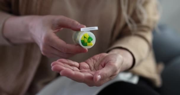 Elderly Woman Pouring Medicine Capsules Hand Jar Closeup Movie Slow — Stock Video