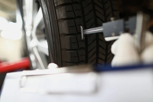 stock image Visiting tire shop and assessing car tire damage. Tread wear and tire life concept