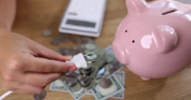 Woman Tries Insert Electric Plug Nostrils Piggy Bank Charge Pink — Stock Video