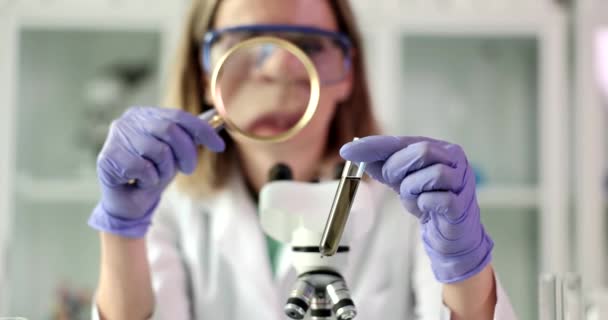 Scientist Chemist Expert Looks Magnifying Glass Test Tube Liquid Sample — Stock Video