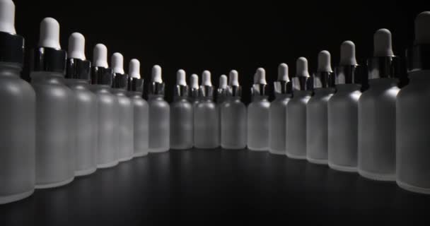 stock video Transparent frosted bottles for cosmetics in production. Shelf life and storage features of essential oils