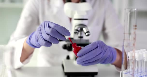 Scientist Examines Red Nail Polish Laboratory Experts Have Warned Deadly — Stock Video
