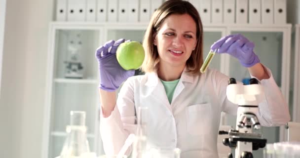 Positive Scientist Looks Test Tube Yellow Liquid Fresh Apple Hands — Stock Video