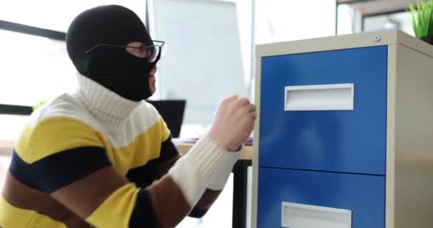 Man Thief Criminal Balaclava Opens Shelf Steals Information Office Theft — Stock Video