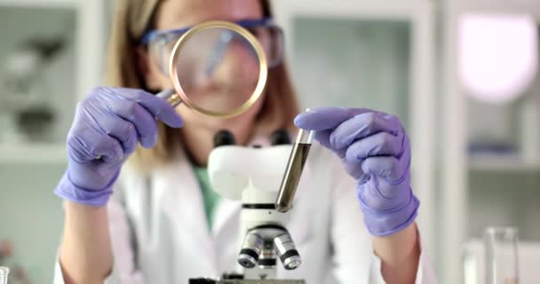 Scientist Biologist Looks Test Tube Liquid Solution Magnifying Glass Scientific — Stock Video