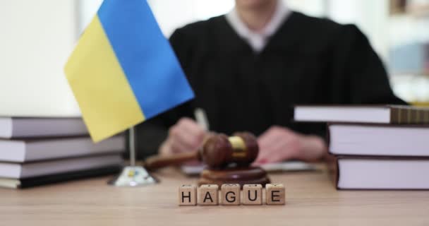 Word Hague Written Wooden Cubes Flag Ukraine Judge Courtroom Closeup — Stock Video