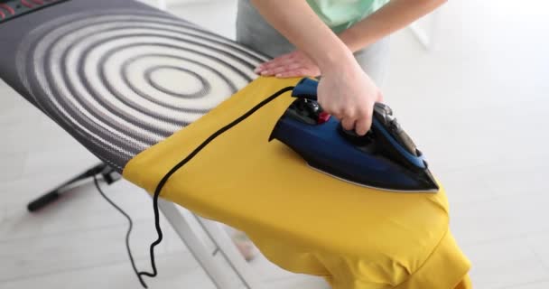 Woman Hand Holds Steam Iron Irons Yellow Dress Ironing Clothes — Stock Video