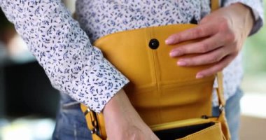 Kadın akıllı telefonu deri çantadan çıkarıyor. Cep telefonu kullanımı