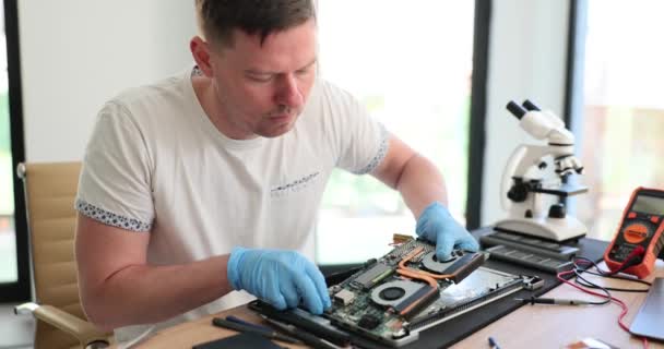 Man Rubber Gloves Carefully Removes Detail Broken Laptop Workshop Skilled — Stock Video