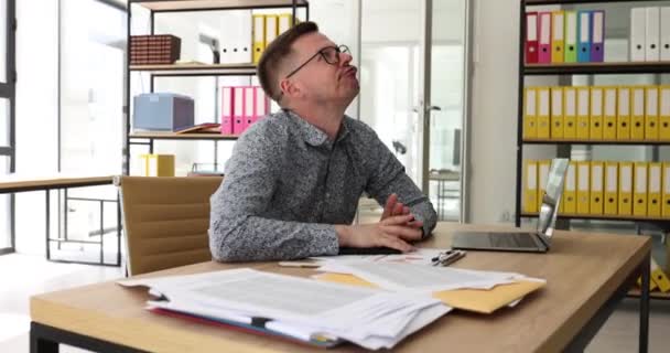 Man Thinks Looking Ceiling Supporting Head Hand Employee Sits Shelves — Stock Video