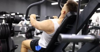 Erkek vücut geliştirici spor simülatörü 4k film yavaş çekim konsepti üzerinde kol kasları egzersizleri yapıyor.