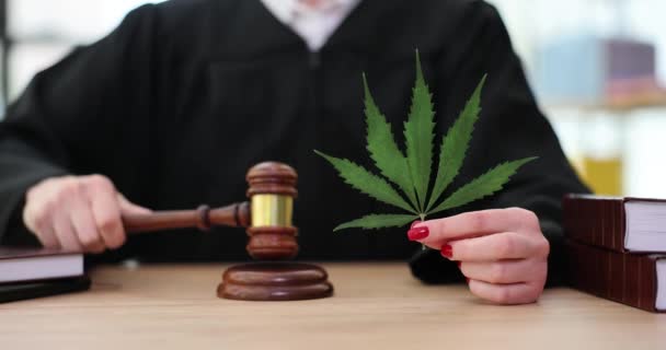 マリファナの葉を手に裁判官は法廷で砂利でノックします 大麻取引罰則 — ストック動画