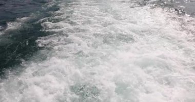 Dalgalı ve köpüklü su teknenin arkasında. Deniz manzarası.