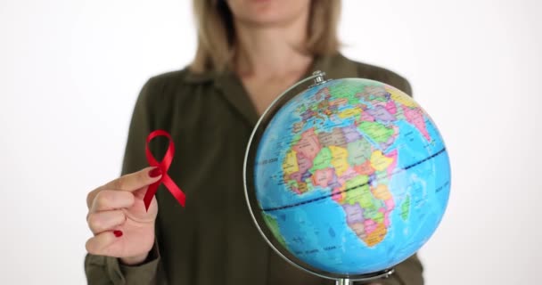 Woman Shows Red Ribbon Fight Aids Symbol Globe Sign Awareness — Stock Video