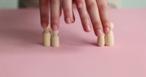 Woman Replaces Small Wooden Figures Conceptual Children Divorce Pink Surface — Stock Video