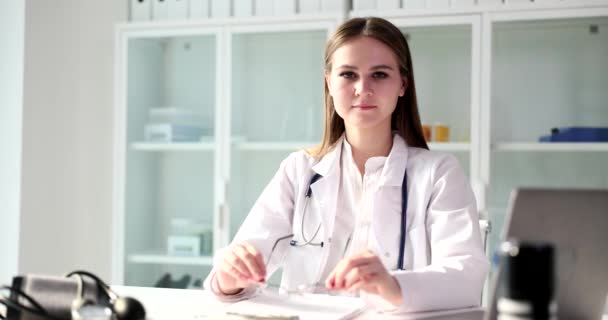 Joven Doctora Pone Gafas Mirando Cámara Mujer Seria Uniforme Médico — Vídeos de Stock