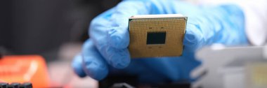Technician puts processor on computer motherboard socket. Computer chip board and installation
