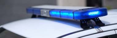 Closeup of blue lights on roof of police car. Flashing beacons of police car and arrest of criminal