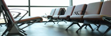 Modern airport waiting area with leather seats. Vacation and travel concept