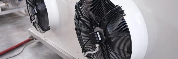 Cooling industrial air conditioners and fans closeup. Maintenance of ventilation systems concept
