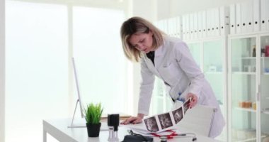 Doktor elleri klinikte ultrason taramasını tutar ve inceler. İç organların ultrasonu