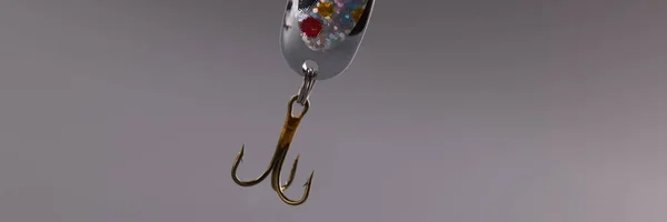 Fishing tackle with bait and hook on gray background. Fishing accessories concept