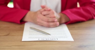 Female hands of lawyer agent or business partner with contract and pen. Signing and conclusion of contract