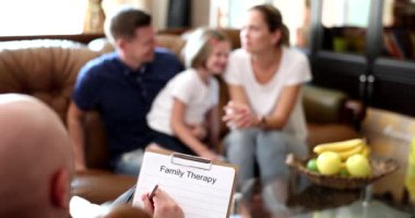 Upset child by parents at psychologists appointment. Family at session of psychology and psychologist helps young family with child to solve problems