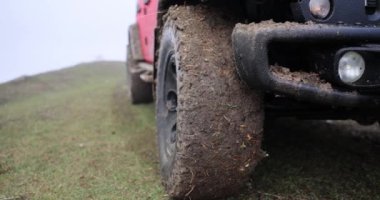 Car wheel with dirty wheels standing on rural road. Off-road driving concept