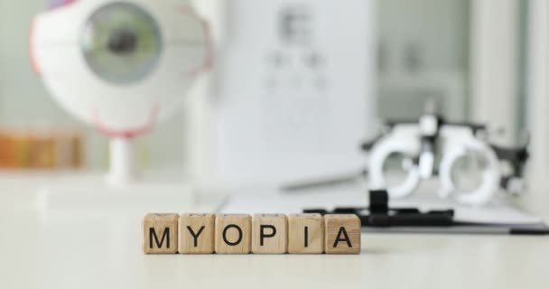 Myopia Inscription Wooden Cubes Table Clinic Close Eye Disease Diagnostics — Stock Video
