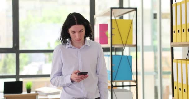 Joven Pasa Por Oficina Mira Smartphone Primer Plano Interior Del — Vídeos de Stock