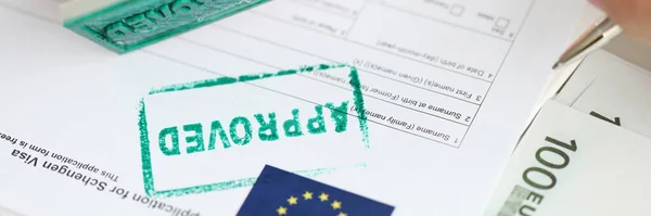 Stock image Approval of visa for travel to European Union, an employee of embassy puts stamp. Getting Schengen visa concept