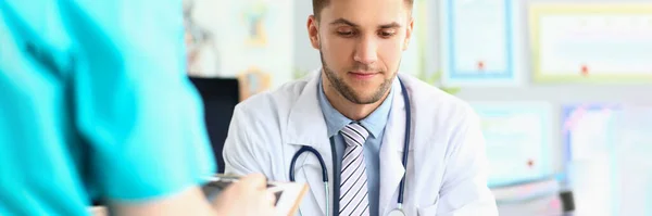 Male Doctor Carefully Examines Documents Office Clinic Workplace Medical Diagnosis — Foto de Stock