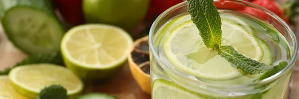 stock image Lime with cucumber punch with mint and ice in glass. Homemade chilled vitamin smoothie closeup