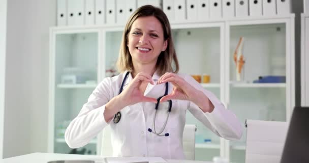 Portrait Smiling Female Doctor Looking Camera Showing Finger Heart Sign — Stock Video