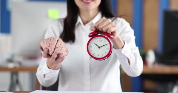 Woman Holding Artificial Human Brain Alarm Clock Documents Graphs Movie — 图库视频影像