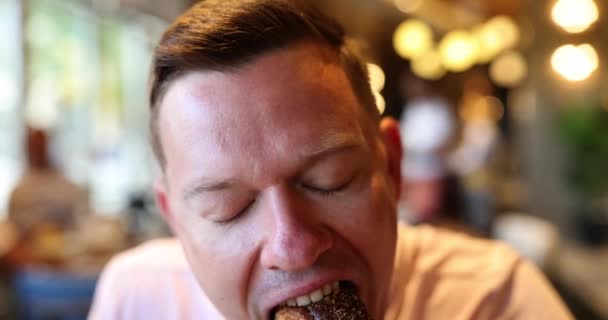Happy Man Biting Delicious Donut Bun Cafe Man Enjoying Lunch — Stock Video