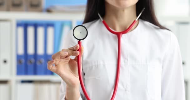 Female Doctor Holding Red Stethoscope Clinic Closeup Movie Slow Motion — Stockvideo