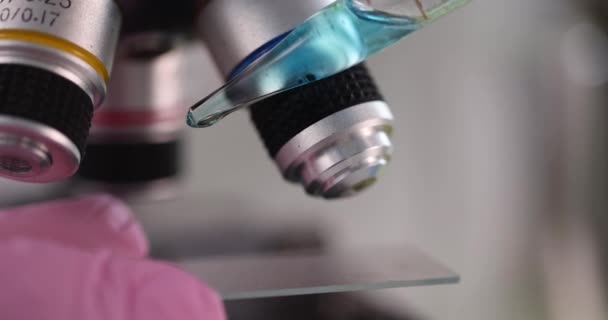 Blue Liquid Examining Microscope Chemical Laboratory Closeup Movie Slow Motion — Vídeos de Stock