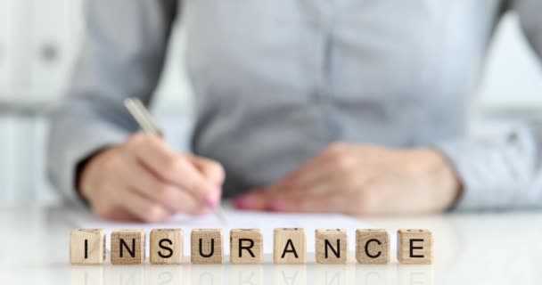 Wooden Cubes Inscription Insurance Agents Desk Close Shallow Focus Insured — Stockvideo
