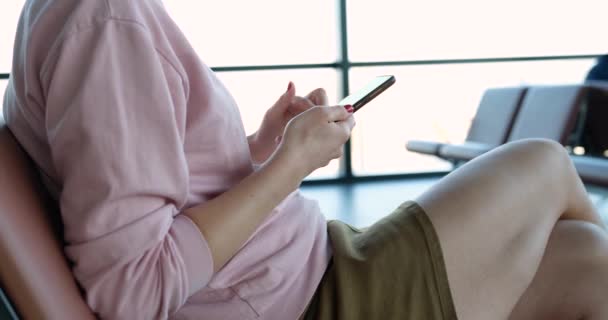 Girl Sitting Chair Waiting Room Smartphone Her Hands Close Airport — 图库视频影像
