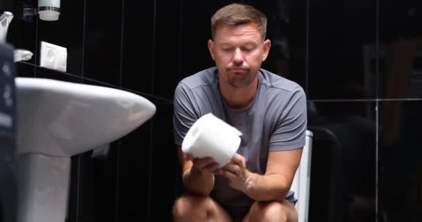 Bored Man Roll Paper Sits Toilet Close Irritable Bowel Syndrome — Stockvideo