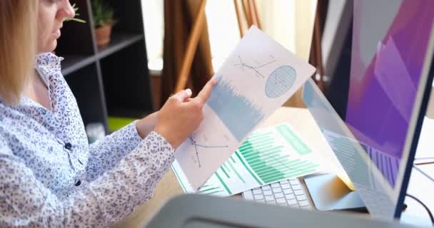Woman Sitting Table Looks Financial Statements Close Analysis Indicators Profit — стоковое видео