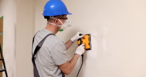 保護マスクやレベルの壁表面にグラインダーで作業ゴーグルのホーム改善プラスター 自宅やオフィスでの壁の修理 — ストック動画