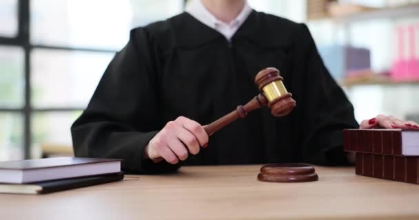 女法官拿着木槌在音块上敲着门 手里拿着法律书籍 法院和司法概念 身穿法官长袍的妇女执法 — 图库视频影像